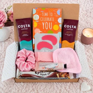 Flat lay of coffee sachets, chocolate, cosy socks and pamper essentials