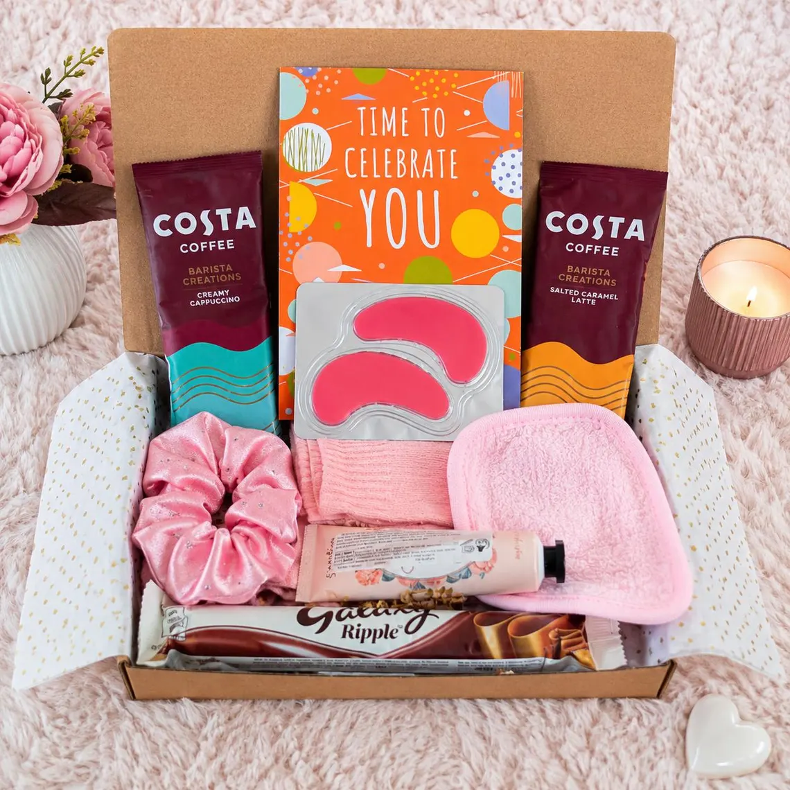 Flat lay of coffee sachets, chocolate, cosy socks and pamper essentials